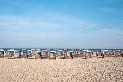 Seats on beach against the sky