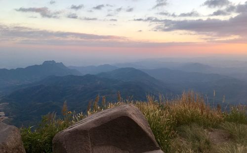 Scenic view of mountains against sky at sunset