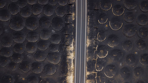 Spain, lanzarote, aerial view of highway cutting through bodega la geria vineyard