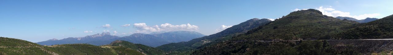 Scenic view of mountains against blue sky