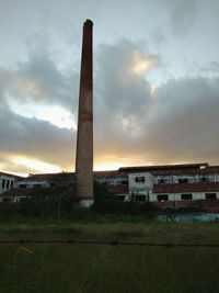 View of factory against cloudy sky