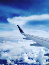 Cropped image of airplane wing against sky