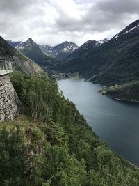 Scenic view of river amidst mountains against sky