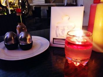 Close-up of lit candles on table