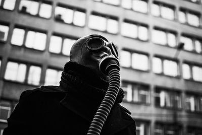 Low angle view of man wearing gas mask