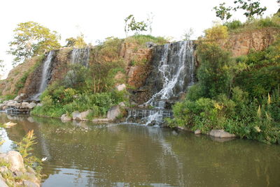 Scenic view of waterfall against sky