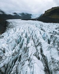 Frozen landscape against sky