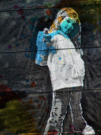 Reflection of woman on multi colored umbrella