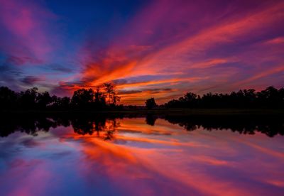 Scenic view of lake against romantic sky at sunset