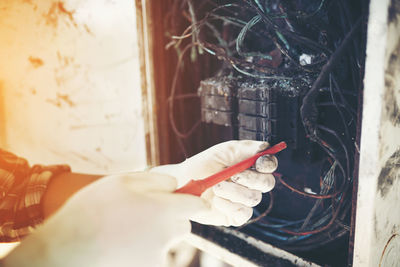 Midsection of man working with cigarette