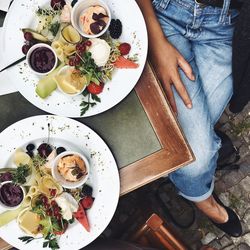 Low section of woman sitting at outdoor restaurant table