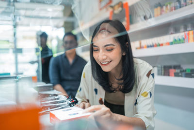 Portrait of young woman using mobile phone