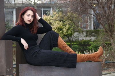 Portrait of young woman sitting outdoors