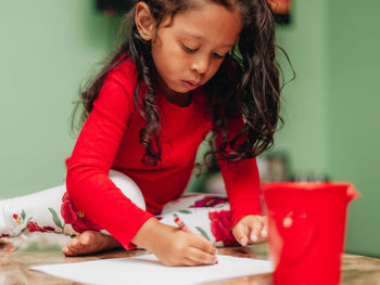 Cute girl sitting on table