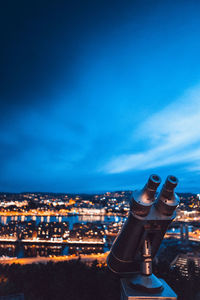 Aerial view of illuminated cityscape against sky at night