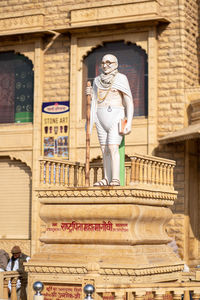 Low angle view of statue against building