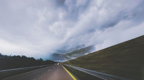 Surreal road with vanishing point against sky