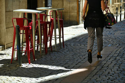 Low section of man walking on street