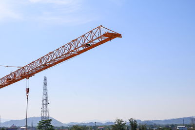 Low angle view of crane against sky