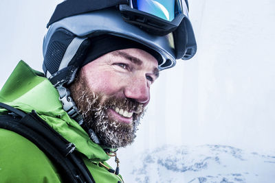 Close-up of smiling man wearing helmet