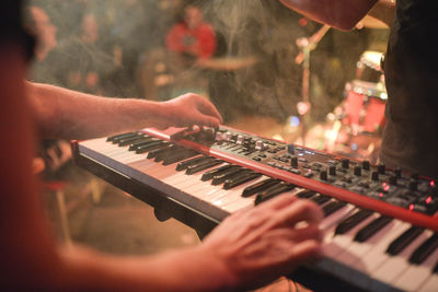 Close-up of hands playing piano