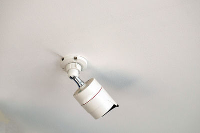 Low angle view of electric lamp on wall