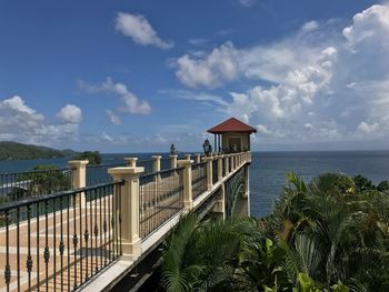 Built structure by sea against sky