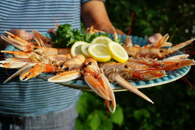 Midsection of man eating food