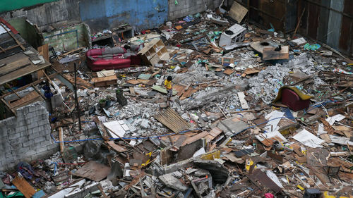 High angle view of boy standing at junkyard