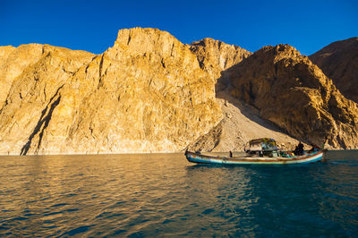 Scenic view of sea and mountains against clear sky