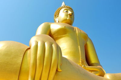 Low angle view of statue against blue sky