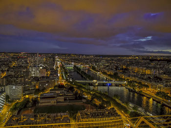 High angle view of illuminated cityscape against sky at dusk