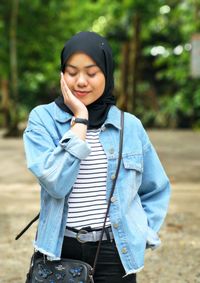 Smiling girl in hijab standing outdoors