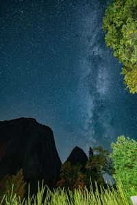 Scenic view of mountains against sky at night