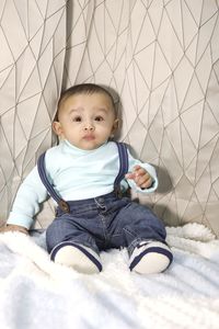 Cute baby girl sitting on floor