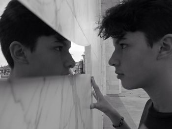 Side view of mother and daughter at home