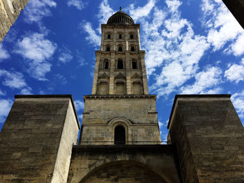 Low angle view of church against cloudy sky