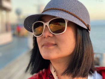 Close-up of woman wearing sunglasses standing outdoors