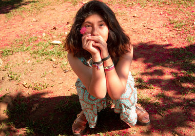 Young woman with a flower on a sunny day