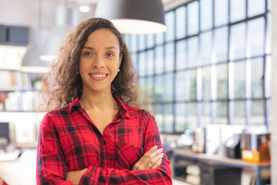 Modern businesswoman at the office, smiling female boss posing for a company photograph,