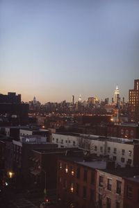 High angle view of illuminated buildings against clear sky