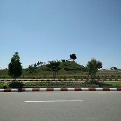 View of trees against clear blue sky