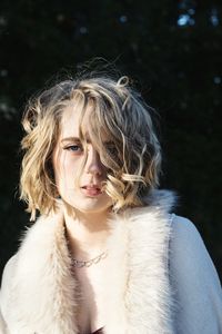 Portrait of young woman wearing fur coat