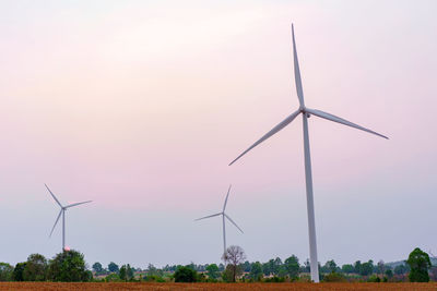 Wind turbine renewable energy source summer with blue sky.