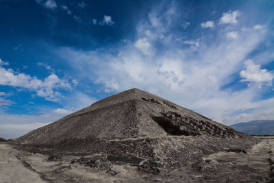 View of desert against cloudy sky