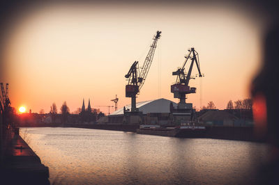 Silhouette of cranes at construction site