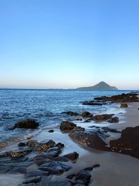 Scenic view of sea against clear blue sky