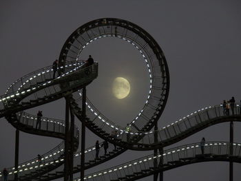 Low angle view of illuminated ferris wheel against sky