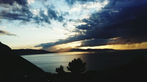 Scenic view of sea and mountains during sunset