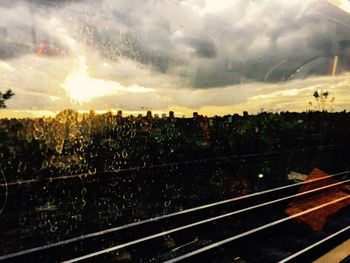 Close-up of railroad tracks against sky during sunset